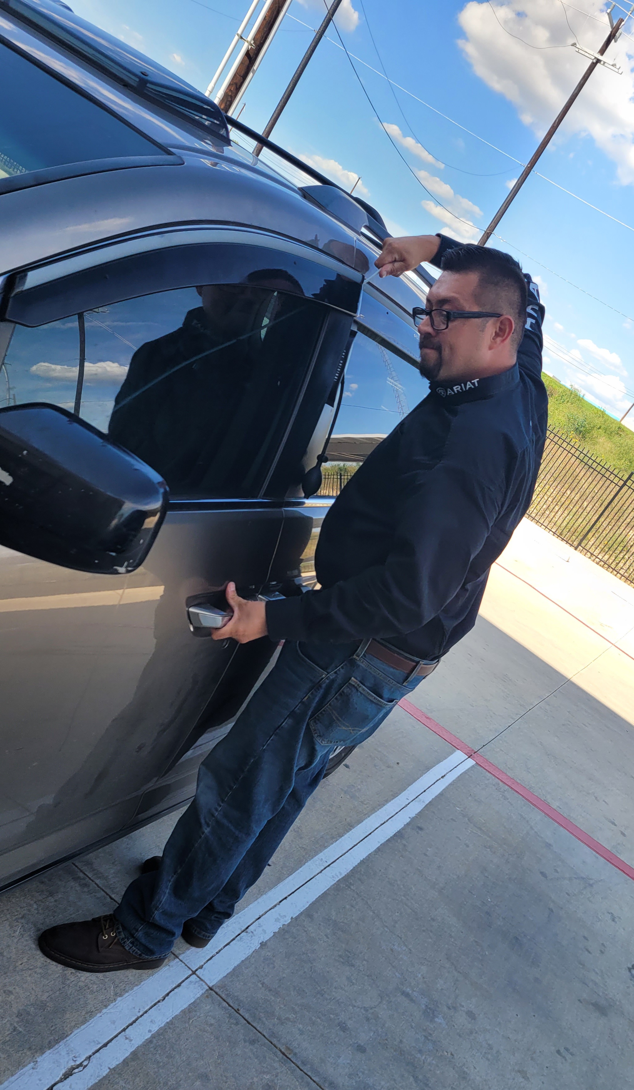 Nick unlocking a gray SUV in a San Antonio parking lot
